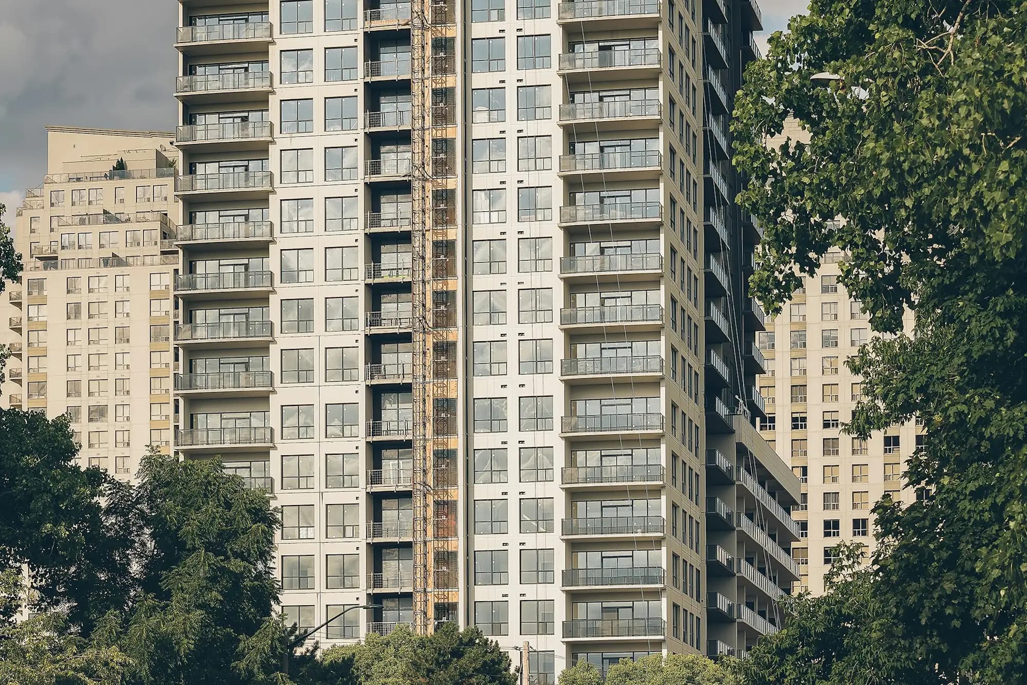 A condominium tower among trees in downtown London, Ontario