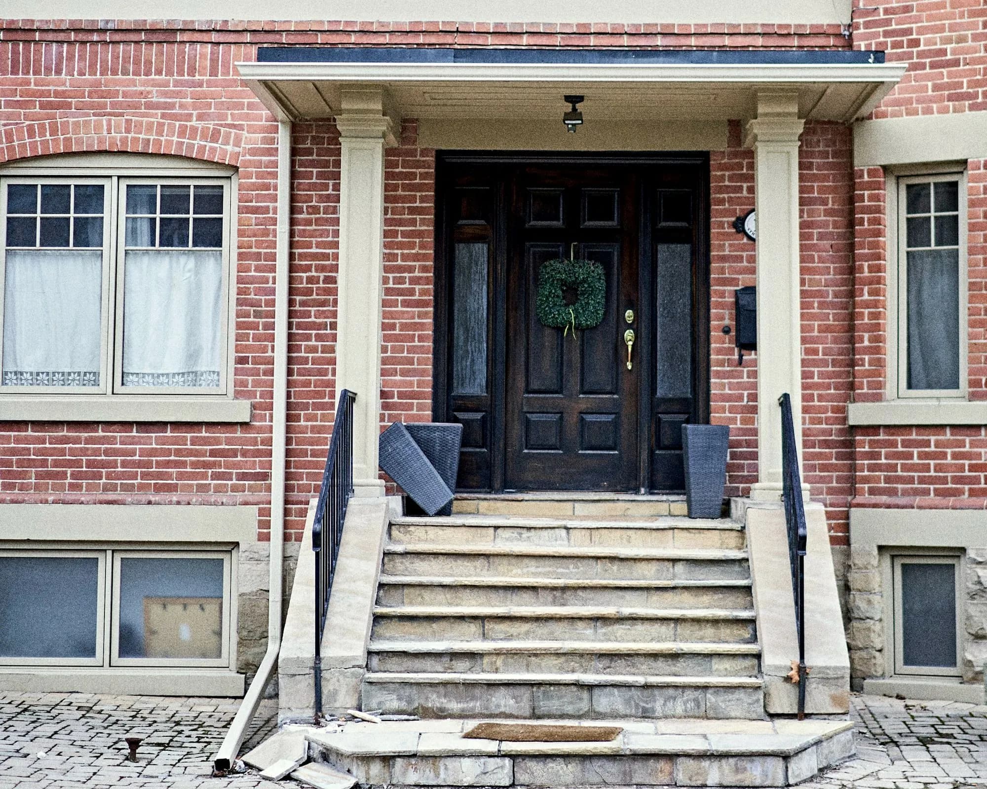 Front steps leading up to the door of a brick house in Toronto