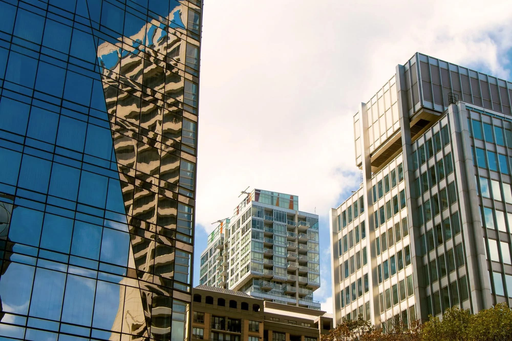 Glass residential towers in Toronto against a blue sky